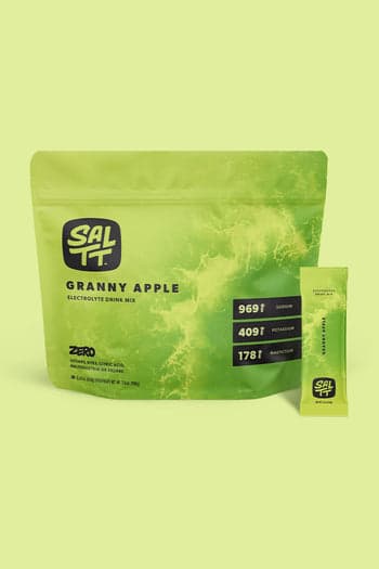 SALTT Granny Apple Electrolyte Drink Mix, lime green pouch and matching stick pack, both featuring an ocean water splash design.