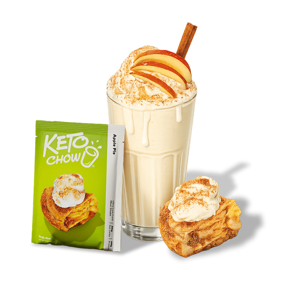 Green Keto Chow Apple Pie packet, shake with whipped cream, apple slices, cinnamon stick, and a small apple pastry.