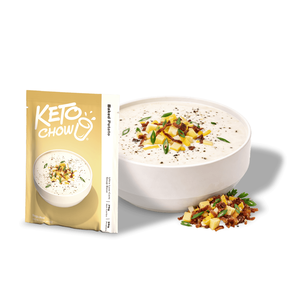 KETO CHOW Baked Potato Soup Base in a gold pouch next to a white bowl of soup topped with potatoes, bacon, and green onions.